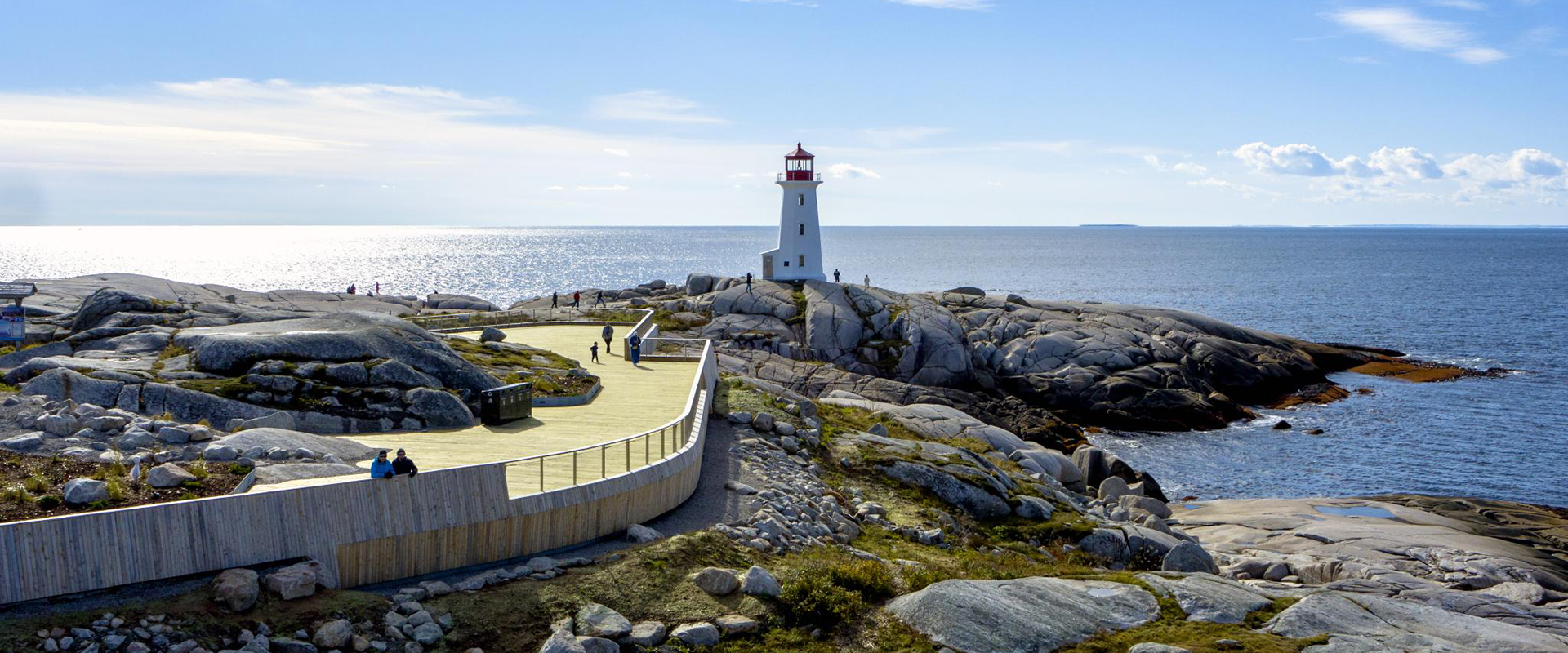 Accessible viewing deck at Peggys Cove with lighthouse in the background.