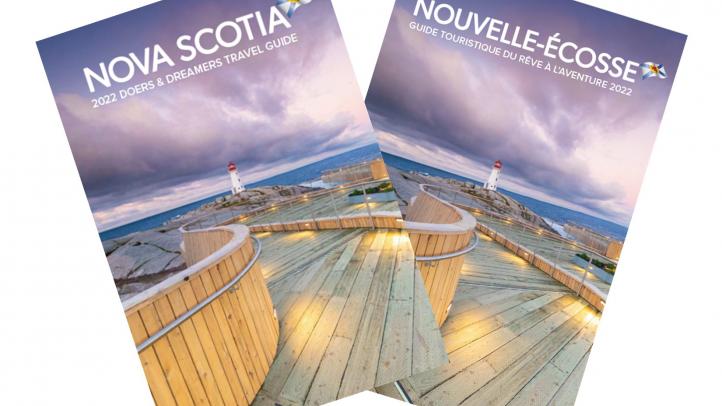 Fanned cover images of the 2022 English and French Nova Scotia travel guide