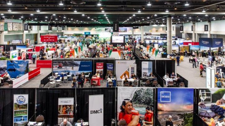 Large conference room with several tourism booths