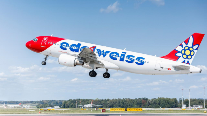 An Edelweiss branded aircraft is taking off from an airport. We can see the runway in this image. 