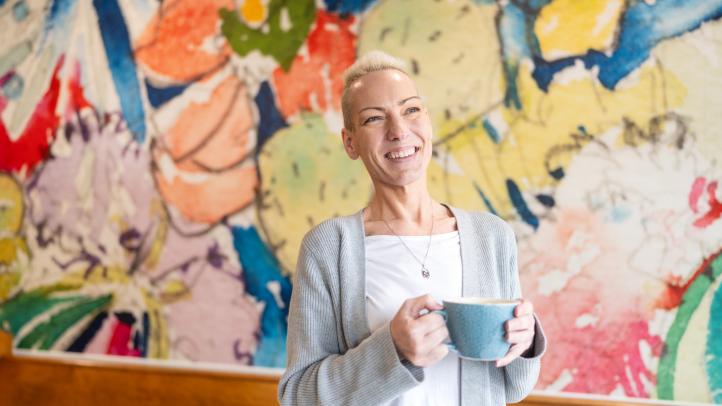 Cheryl MacLean stands with a coffee cup in hand at Marmalade Motel in Port Dufferin.